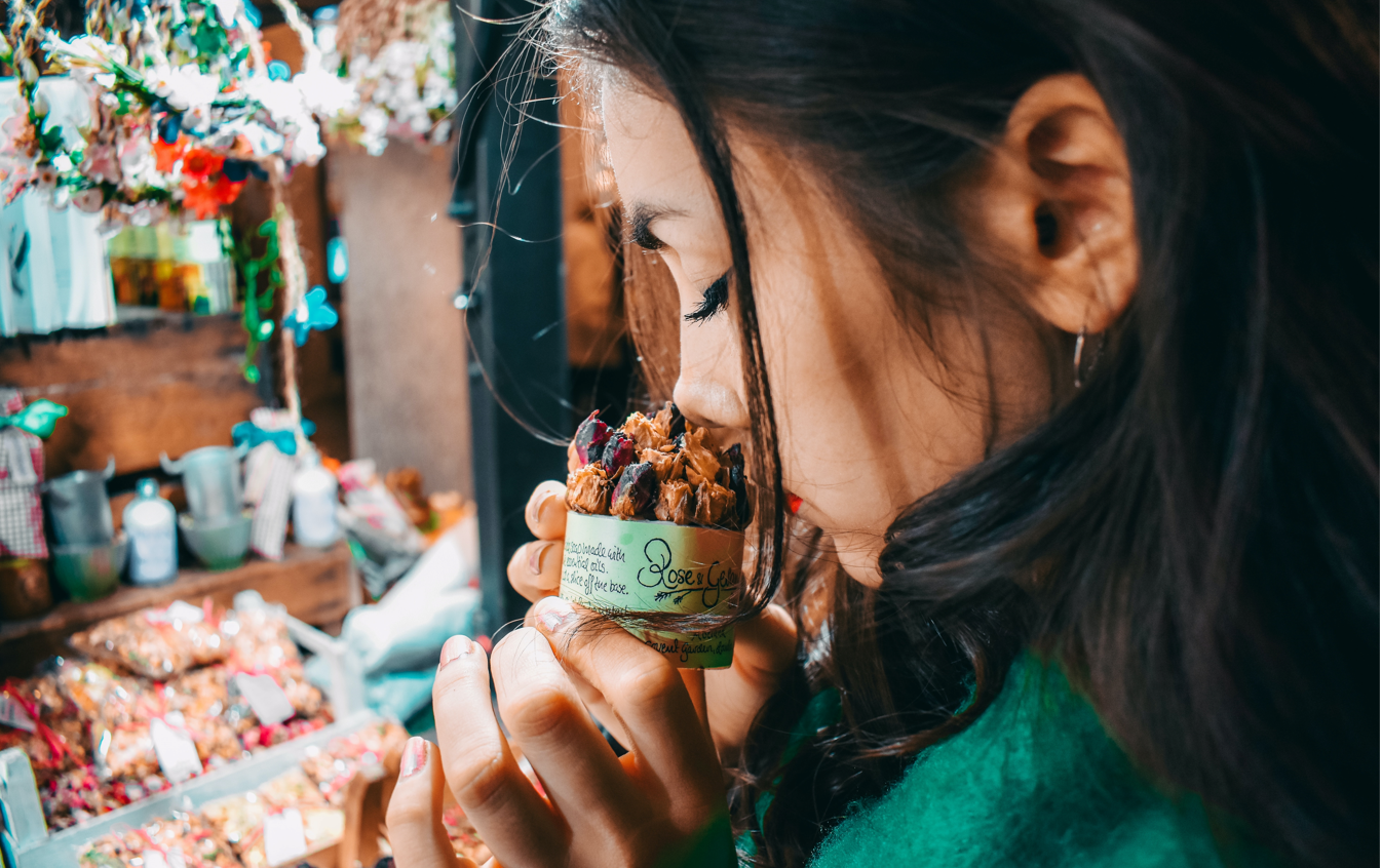 woman smelling a product in a store