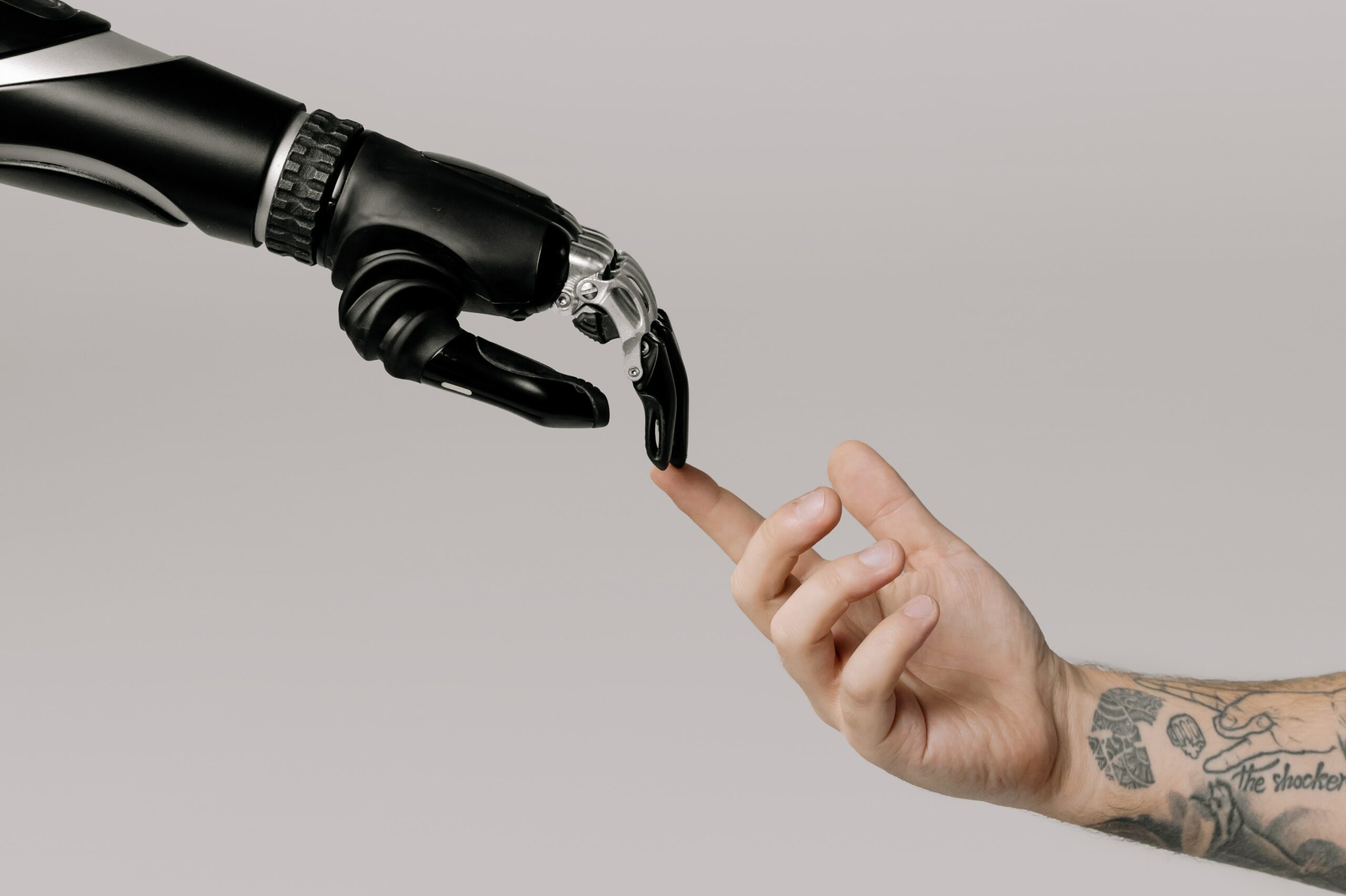 a robot and human touch fingers