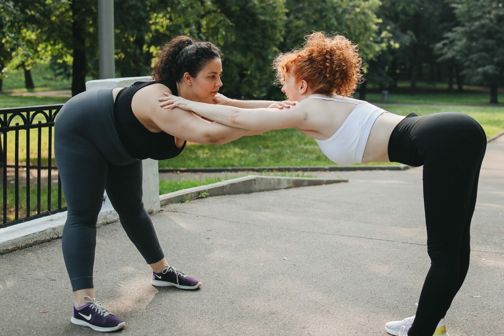 two women work out together outside