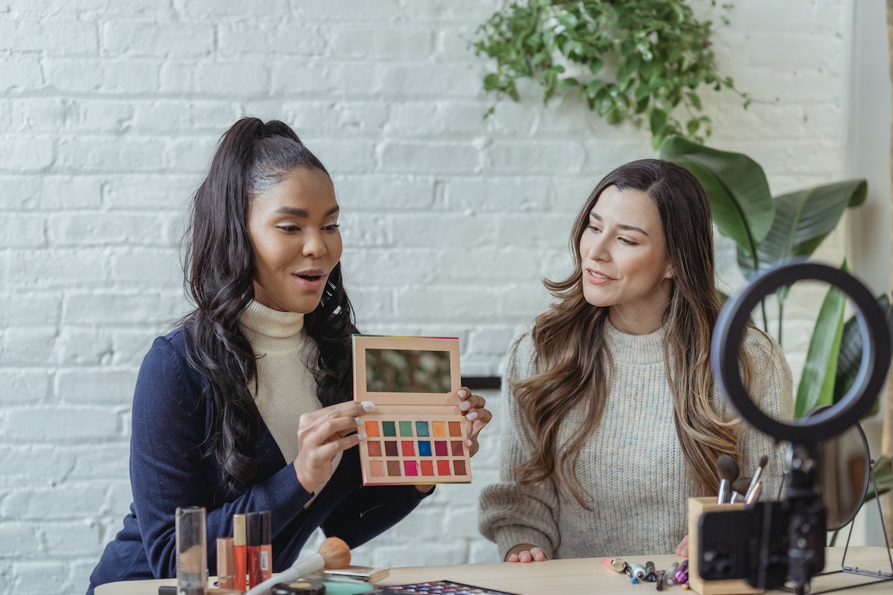 a couple of marketing influencers showing their products online